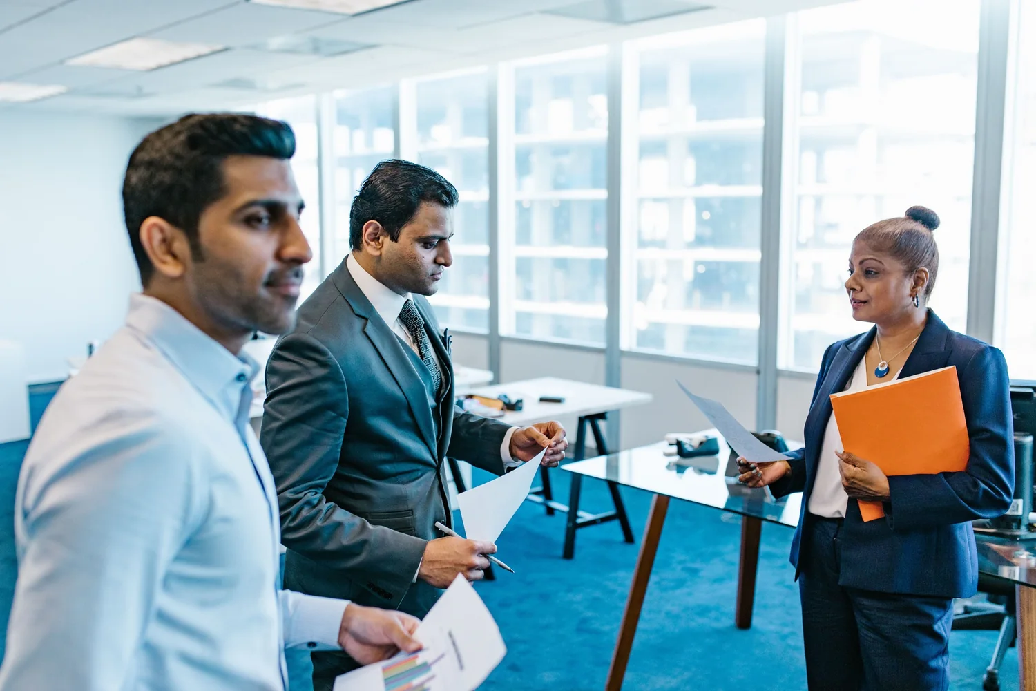 Legal consultants going through a client file in a Dubai office