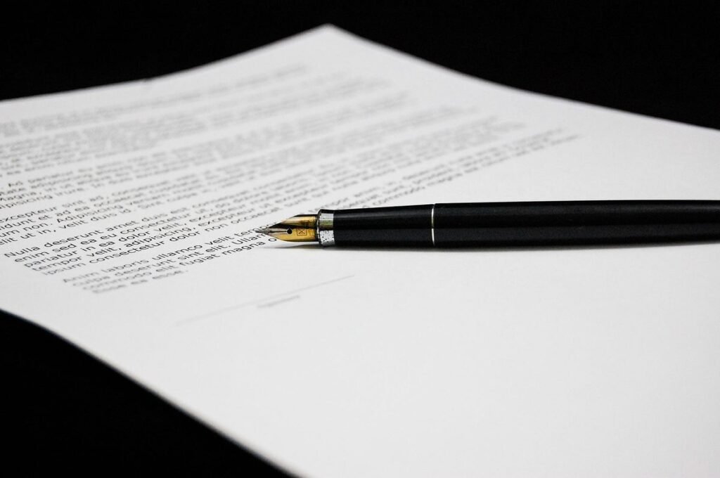 Fountain pen resting on a printed document ready for signing at a desk